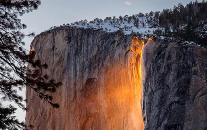 Yosemite National Park’s Horsetail Fall flows down famed rock formation, El Capitan.