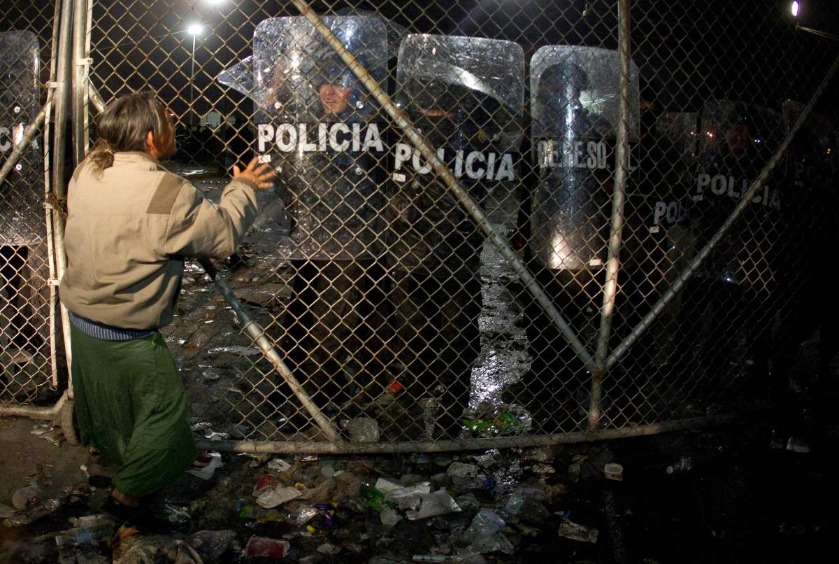 An inmate relative confronts police protecting the perimeter at the Apodaca state prison near Monterrey, Mexico Tuesday Feb. 21, 2012. The government of Nuevo Leon is investigating alleged inmate abuse at a prison in Apodaca. 