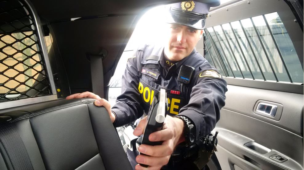An OPP officer holds a breathalyzer, used to test blood alcohol levels.