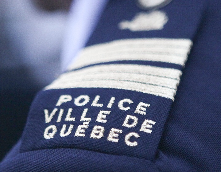 Ville de Quebec Police badge is seen.