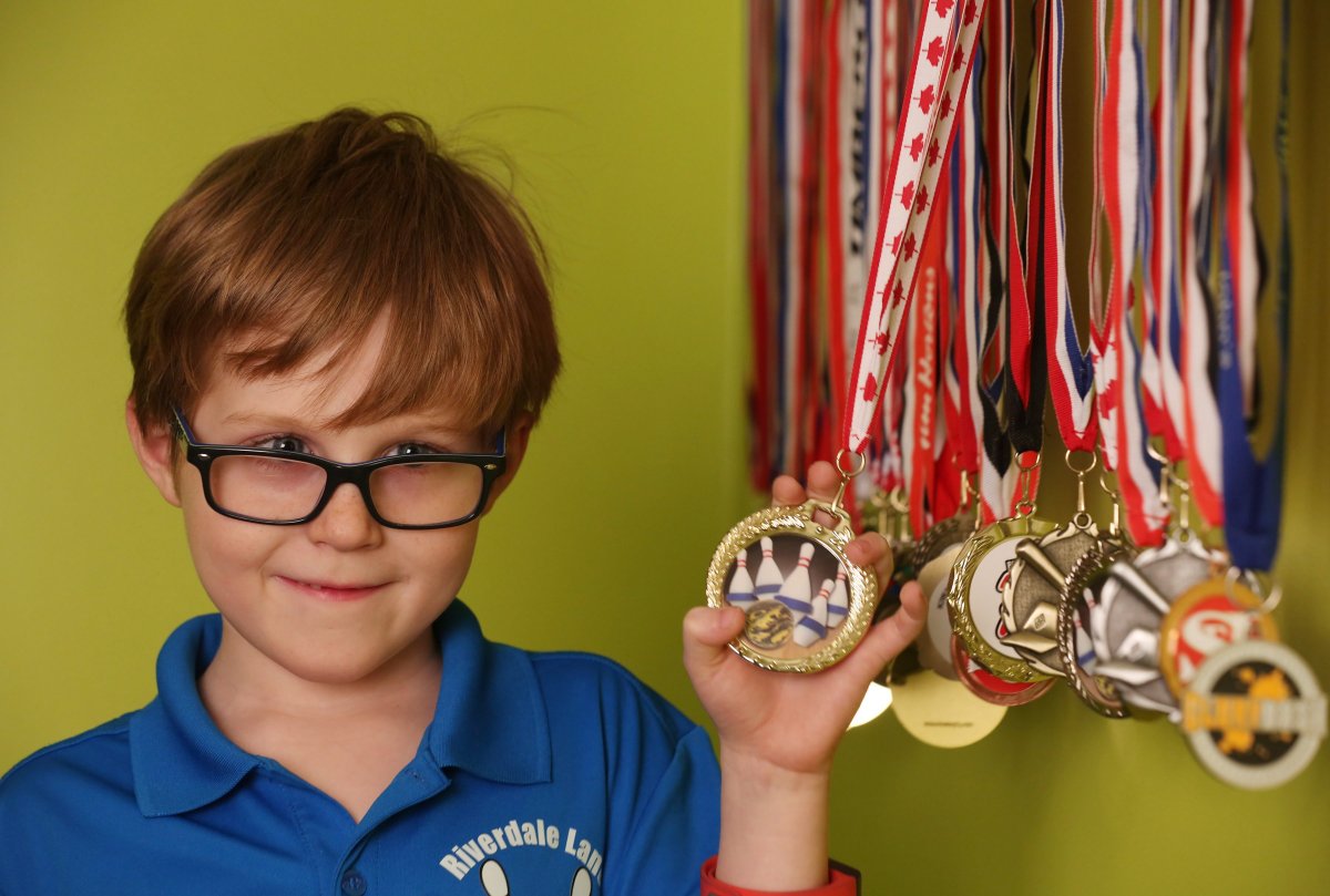 Seven-year-old Grayson Powell shows off his bowling and other sporting medals at home in Conception Bay South, N.L. on Wednesday, March 1, 2017. 