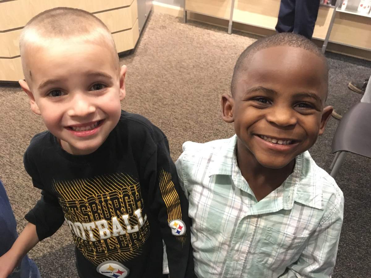 In this Feb. 28, 2017, photo, 5-year-olds Jax, left, and Reddy smile after Jax got a haircut similar to his friend’s at the Great Clips in Louisville, Ky.