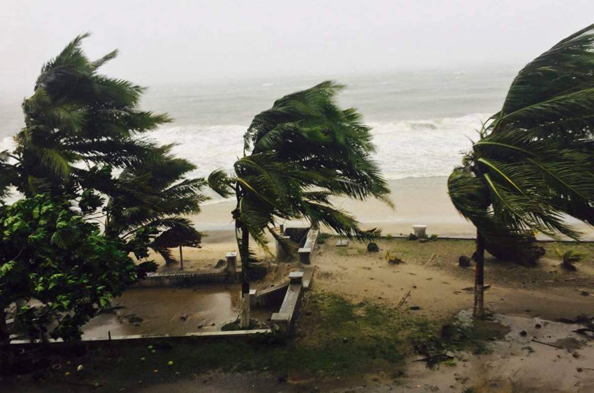 Trees are lashed by strong winds in Sambava, Madagascar Tuesday, March 7, 2017 as heavy rains and strong winds from a cyclone hit northeast Madagascar, raising concerns about flooding and landslides. Aid workers were on alert as Cyclone Enawo lashed the coastline.