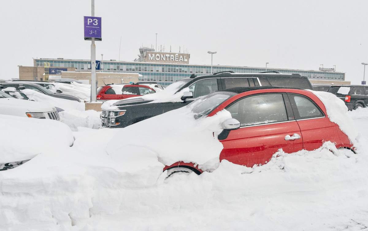 Snow-covered cars at Pierre Elliott Trudeau Airport, Thursday, March 16, 2017.