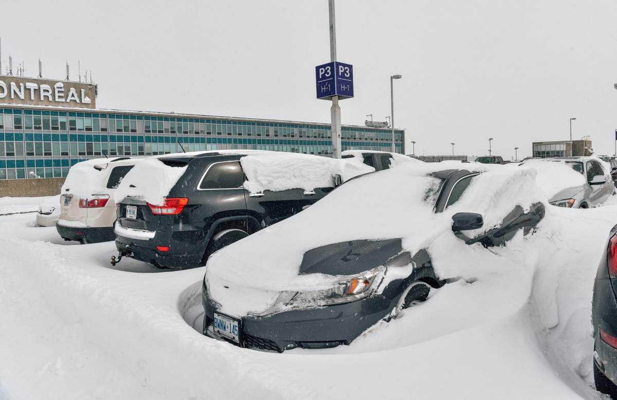 Snow-covered cars at Pierre Elliott Trudeau Airport, Thursday, March 16, 2017.
