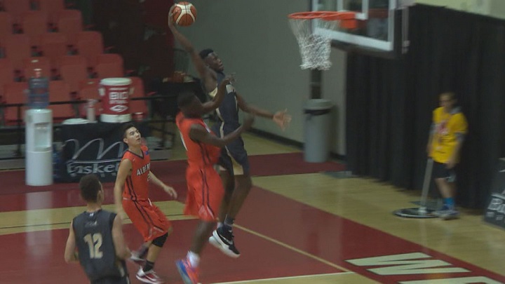 Emmanuel Akot gets a slam dunk for Team Manitoba at the U17 Boy's National Championships in August/2016.