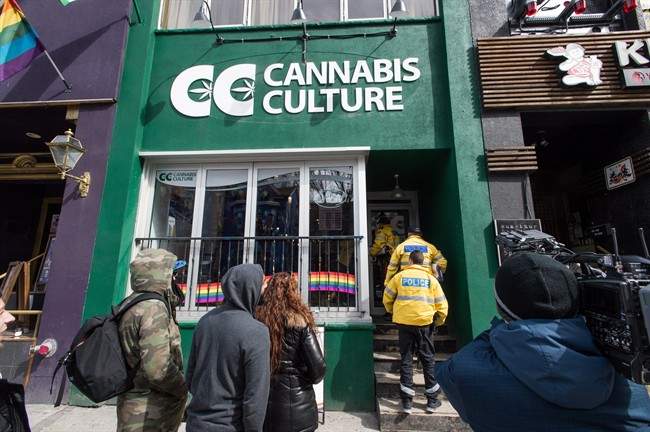 Store employees, media, and supporters are seen outside the Cannabis Culture store on Church Street during a police raid in Toronto on Thursday, March 9, 2017. Prominent marijuana activists Marc and Jodie Emery have been arrested in Toronto and police are raiding several pot dispensaries associated with the couple.