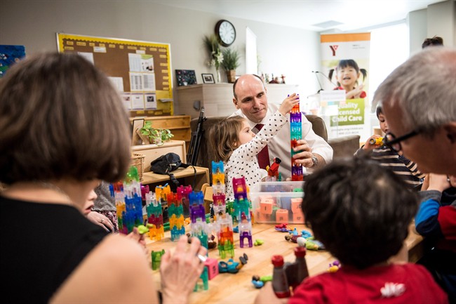 Jean-Yves Duclos, minister of Families, Children and Social Development, plays with children at a YMCA daycare in downtown Toronto before announcing federal budget measures to support early learning and child care for middle class families on Wednesday, March 29, 2017.
