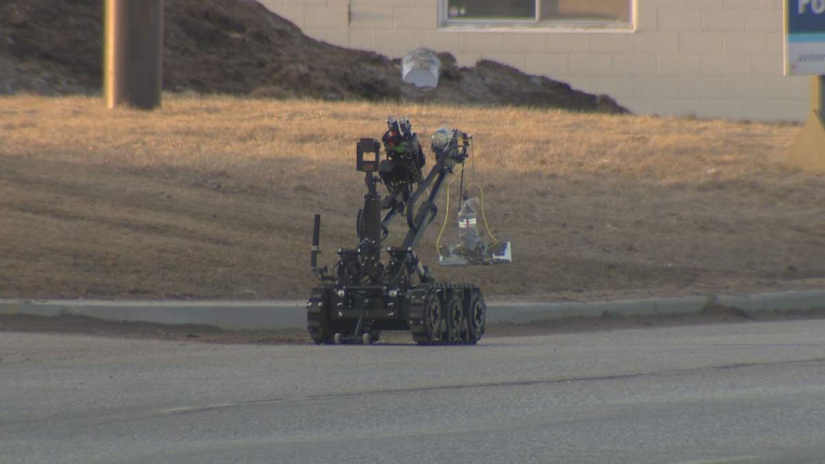 The Winnipeg police bomb squad robot can be seen holding an item Monday evening.