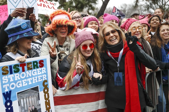 In this Jan. 21, 2017 file photo, Gloria Steinem, center right, greets protesters at the barricades before speaking at the Women's March on Washington during the first full day of Donald Trump's presidency, in Washington.