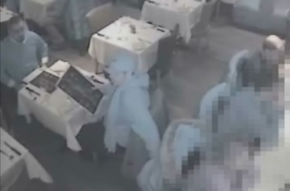 On the surveillance video provided by Laval police, a suspect is seen sitting at a table.