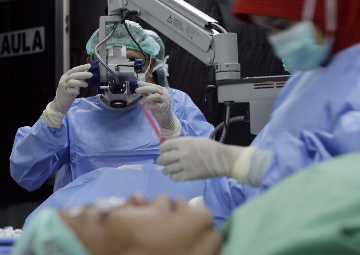 A doctor conducts a cataract surgery on a patient at a hospital in Jakarta, Indonesia, Thursday, Dec. 3, 2015.