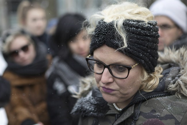 Mandi Gray stands with supporters as she talks with media outside court in Toronto on Tuesday, March 14, 2017.