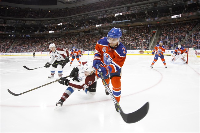 Edmonton Oilers' Andrej Sekera (2) vies for the puck against Colorado Avalanche's Mikko Rantanen (96) during third period NHL action in Edmonton on Saturday, March 25, 2017.