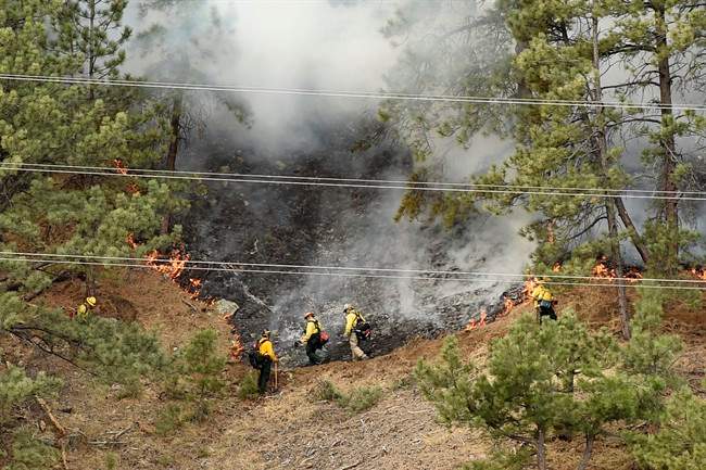 Crews battle the Sunshine Fire in the Sunshine canyon area of Boulder, Colo. on Sunday, March 19, 2017. 