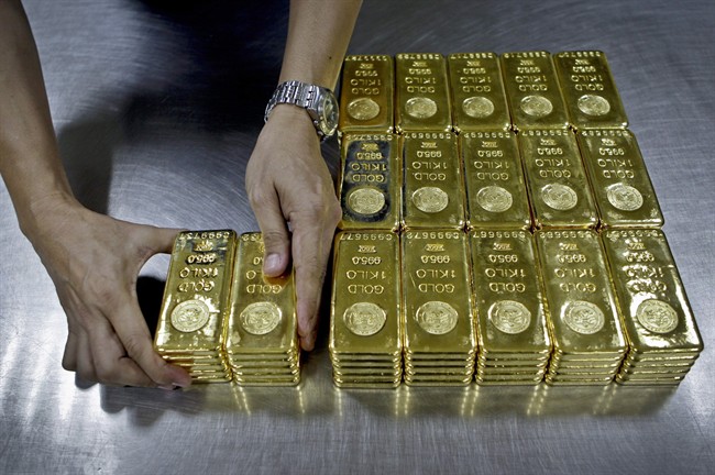 A technician prepares gold bars for delivery in Dubai, United Arab Emirates, Oct.8, 2012. 
