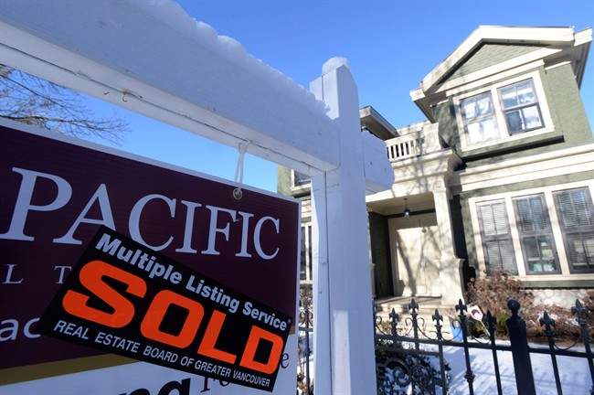 A real estate sold sign is shown outside a house in Vancouver, Tuesday, Jan.3, 2017.