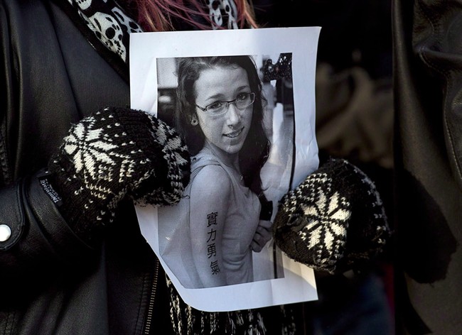 A woman holds a photo as several hundred people attended a community vigil to remember Rehtaeh Parsons at Victoria Park in Halifax on Thursday, April 11, 2013. THE CANADIAN PRESS/Andrew Vaughan