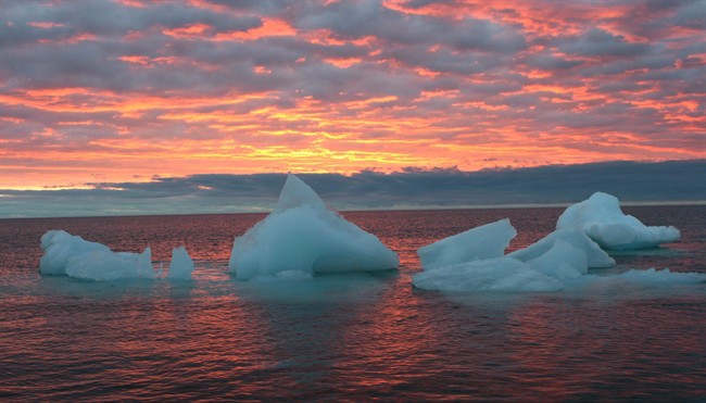 Ice chunks float in the Arctic Ocean as the sun sets near Barrow, Alaska, Sept. 13, 2006.