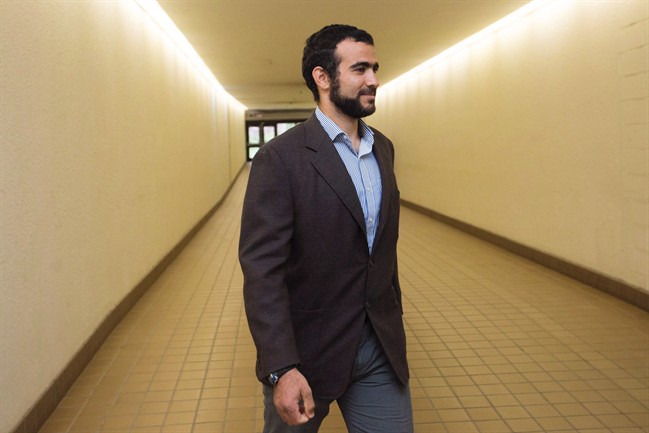 Omar Khadr leaves court after a judge ruled to relax bail conditions in Edmonton on Friday, Sept. 18, 2015. Former Guantanamo Bay inmate Khadr is recovering from a 19-hour operation on a shoulder that was badly injured in Afghanistan 15 years ago, his lawyer said Monday. 