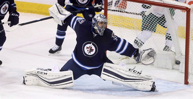 Winnipeg Jets goalie Ondrej Pavelec (31) stretches out to stop a shot by Minnesota Wild's Jason Zucker (not shown). Tuesday, February 7, 2017.