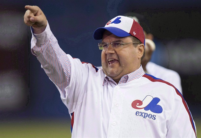 Montreal Mayor Denis Coderre reacts after throwing a ceremonial pitch during a pre-game ceremony as the Toronto Blue Jays face the Cincinnati Reds in MLB exhibition play Friday, April 3, 2015 in Montreal.