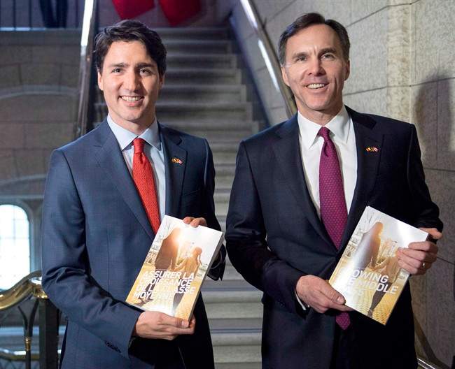 Prime Minister Justin Trudeau (left) walks with Minister of Finance Bill Morneau as he arrives to table the budget on Parliament Hill, Tuesday, March 22, 2016 in Ottawa.