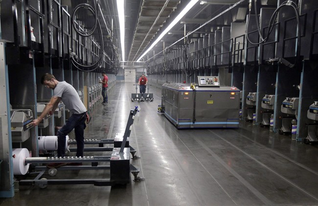 Workers and robots labour side-by-side with plastic thread made from recycled bottles at the Repreve Bottle Processing Center, part of the Unifi textile company in Yadkinville, N.C., in an October 21, 2016, file photo. 