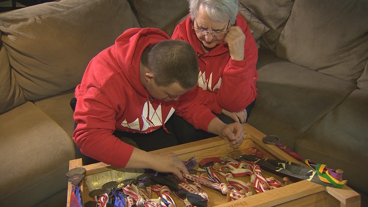 Darren and his mom Tina look over some of the medals he’s won during his three decade long Special Olympics career.
