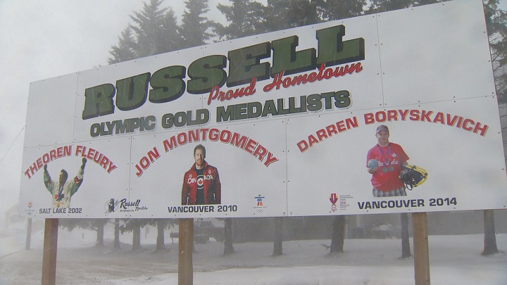 Darren Boryskavich\’s picture sits on Russell\’s welcome sign next to Olympians Theo Fleury and Jon Montgomery.