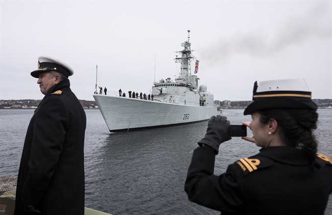 Family, veterans, and dignitaries watch as the HMCS Athabaskan makes its final sail in the Halifax Harbour during the ship's paying off ceremony in Halifax on Friday, March 10, 2017.