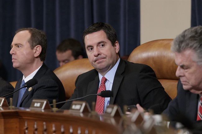 House Intelligence Committee Chairman Rep. Devin Nunes, R-Calif., centre, flanked by the committee's ranking member Rep. Adam Schiff, D-Calif., left, and Rep. Peter King, R-N.Y., listens on Capitol Hill in Washington, Monday, March 20, 2017, during the committee's hearing on allegations of Russian interference in the 2016 U.S. presidential election.