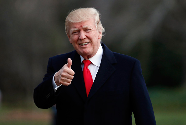 President Donald Trump gives a thumbs up as he walks to the White House after arriving on Marine One, Sunday, March 19, 2017, in Washington. 