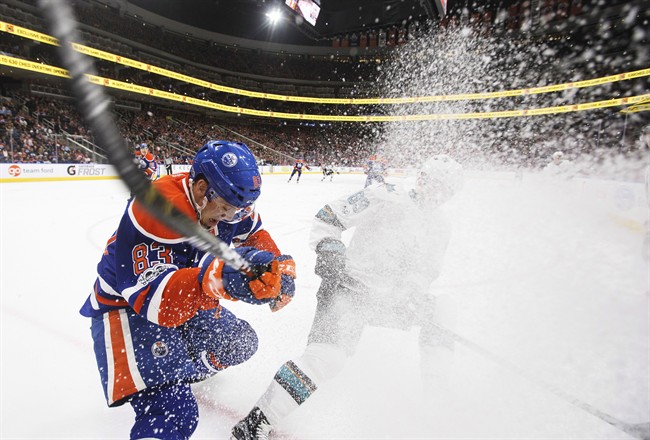 San Jose Sharks' Mikkel Boedker (89) and Edmonton Oilers' Matthew Benning (83) vie for the puck during third period NHL action in Edmonton, Alta., on Thursday, March 30, 2017. 