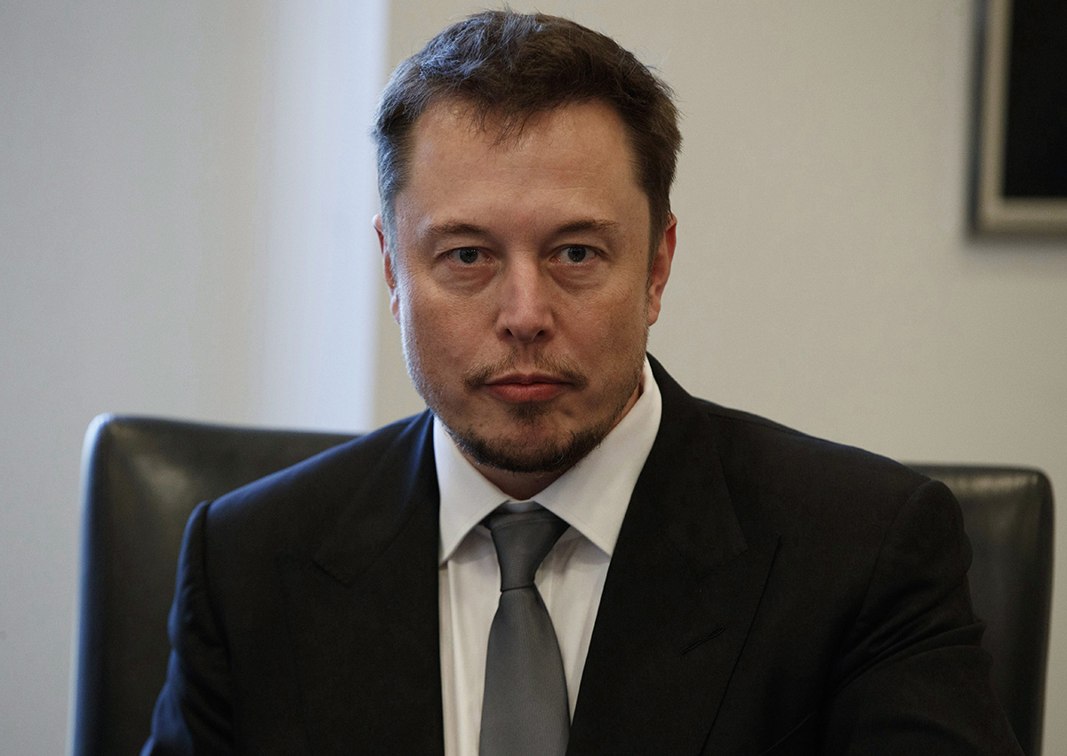In this Dec. 14, 2016, file photo, Tesla CEO Elon Musk listens as President-elect Donald Trump speaks during a meeting with technology industry leaders at Trump Tower in New York., .