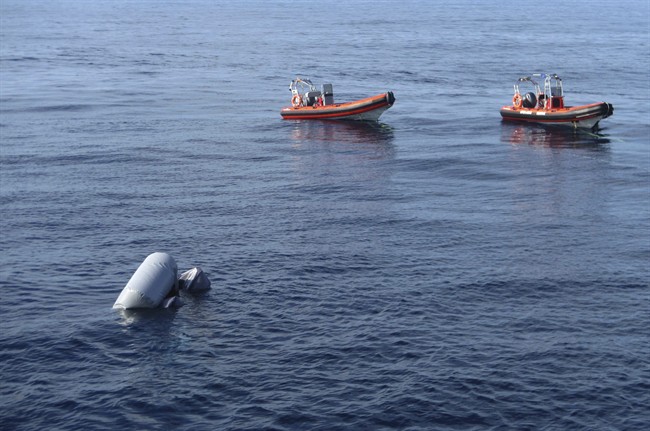 FILE -- In this photo released on Friday, March 24, 2017 a sunken rubber boat in the Mediterranean Sea off the Libyan coast, during a search and rescue operation by Spanish NGO Proactiva Open Arms.