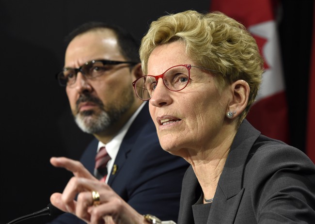 Ontario Premier Kathleen Wynne, right, speaks as Ontario Energy Minister Glenn Thibeault looks on during a press conference in Toronto on Thursday, March 2, 2017. 