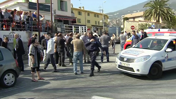 In this image from TV, Police cordon off the area as people gather to view the nearby high school, following a shooting in Grasse, southern France on Thursday March 16, 2017.  