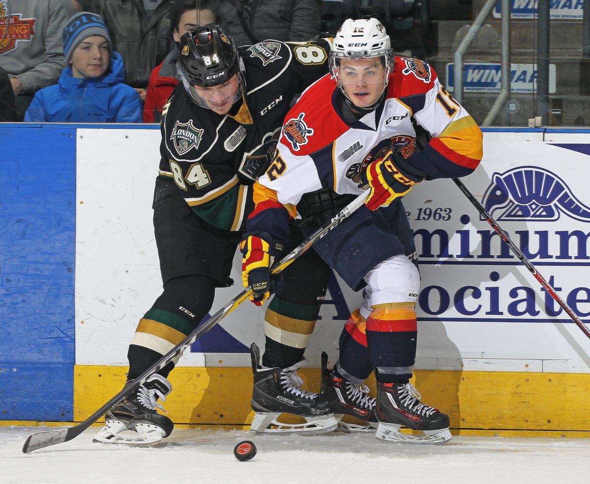 Alex DeBrincat of the Erie Otters battles against JJ Piccinich of the London Knights during an OHL game at Budweiser Gardens in London.