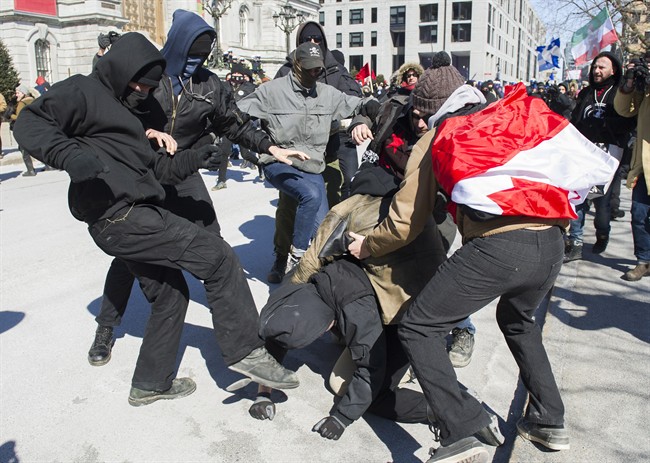 Opposing groups of protesters clash during a demonstration regarding motion M-103 in Montreal, Saturday, March 4, 2017.