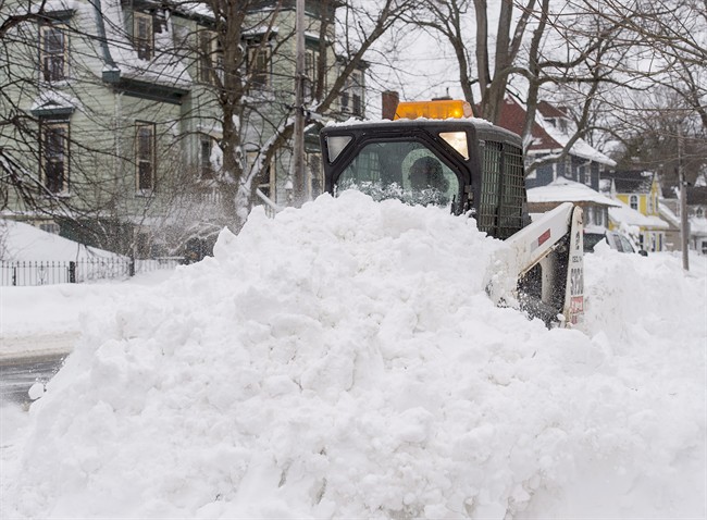 Photo of snow being removed from a sidewalk by a small plow. Hamilton added 469 kilometres in it's snow removal plan for 2022-23 which included sidewalk clearing for the first time.