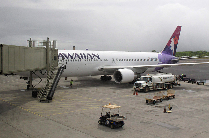 In this April 21, 2014 file photo, a Hawaiian Airlines flight arrives at Kahului Airport in Hawaii.  