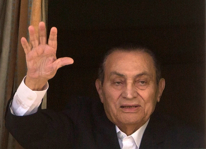 In this April 25, 2016 file photo, ousted Egyptian President Hosni Mubarak waves to his supporters from his room at the Maadi Military Hospital, in Cairo. 