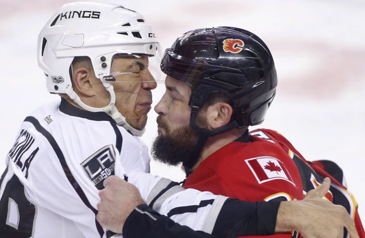 Los Angeles Kings' Jarome Iginla, left, fights with Calgary Flames' Deryk Engelland during first period NHL action in Calgary, Alta., Wednesday, March 29, 2017. 