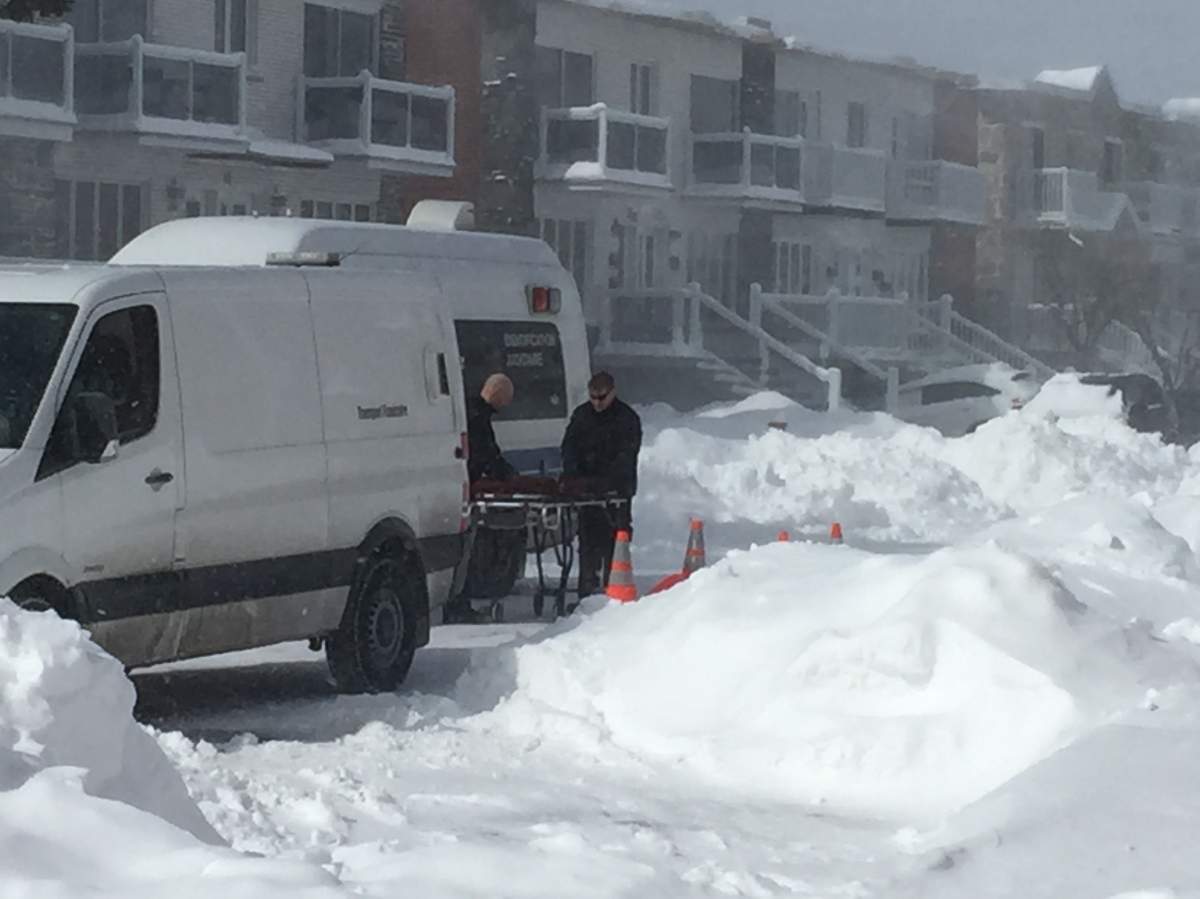 Police officers attend the scene after an 88-year-old man was found dead inside his car on March 16, 2017.