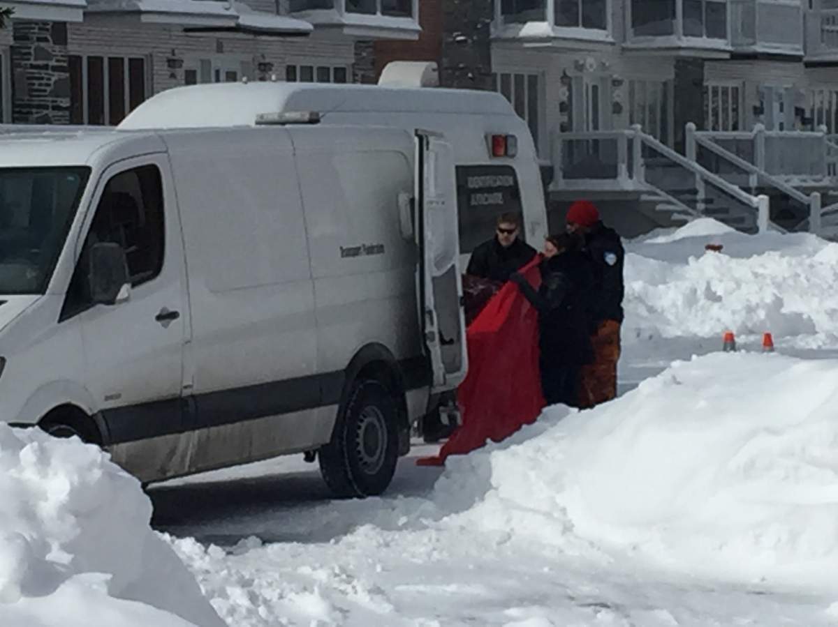 Police officers attend the scene after an 88-year-old man was found dead inside his car on March 16, 2017.
