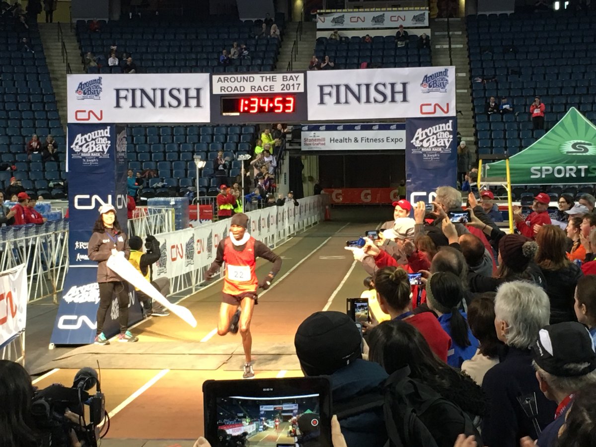 Kenya's Panuel Mkungo crosses the finish line, winning the men's 30-kilometre race.