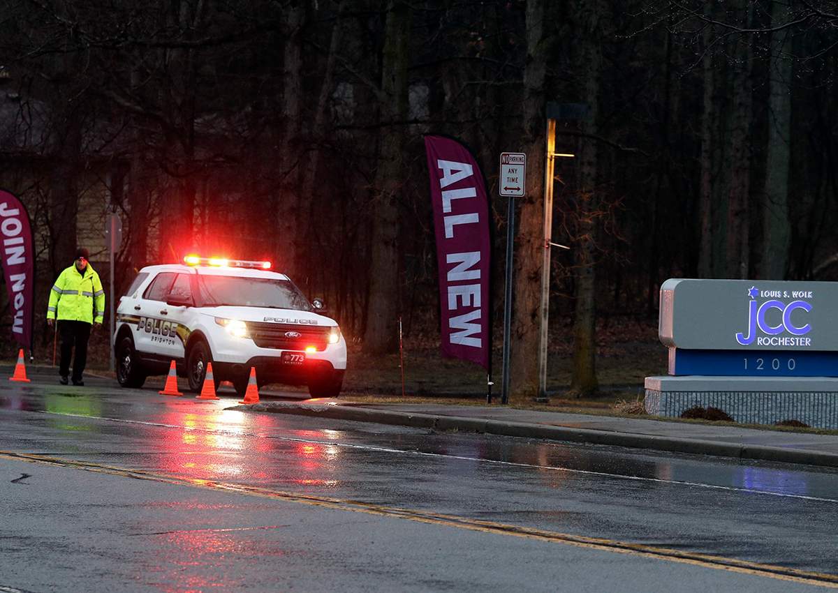 A police officer stands in front of the Louis S. Wolk Jewish Community Center of Greater Rochester after a bomb threat was reported in Brighton, N.Y on Tuesday, March 7, 2017. 