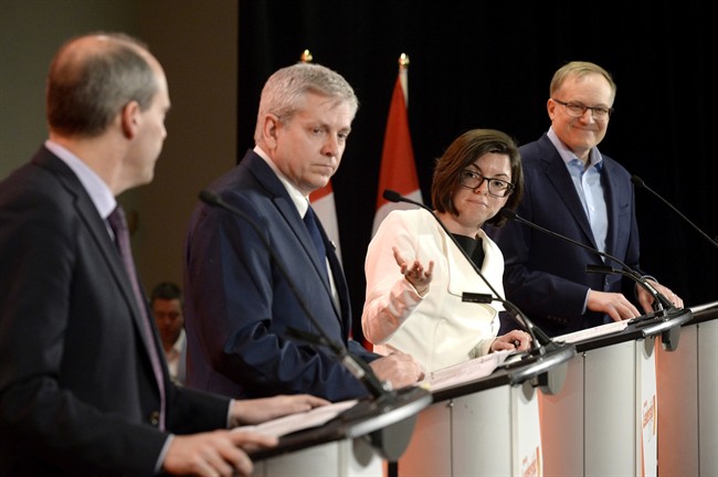 Niki Ashton, second from right, speaks with Guy Caron, left, as Charlie Angus and Peter Julian look on during the first debate of the federal NDP leadership race, in Ottawa on Sunday, March 12, 2017.