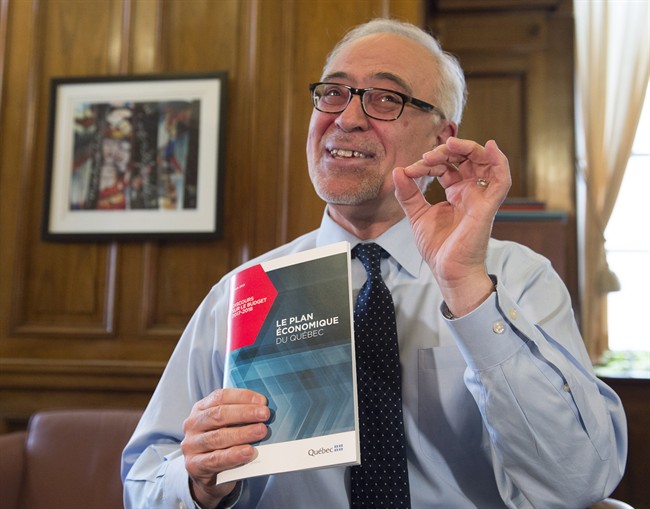 Quebec Finance Minister Carlos Leitao displays his budget speech, on the eve of a provincial budget speech, Monday, March 27, 2017 in Quebec City. 